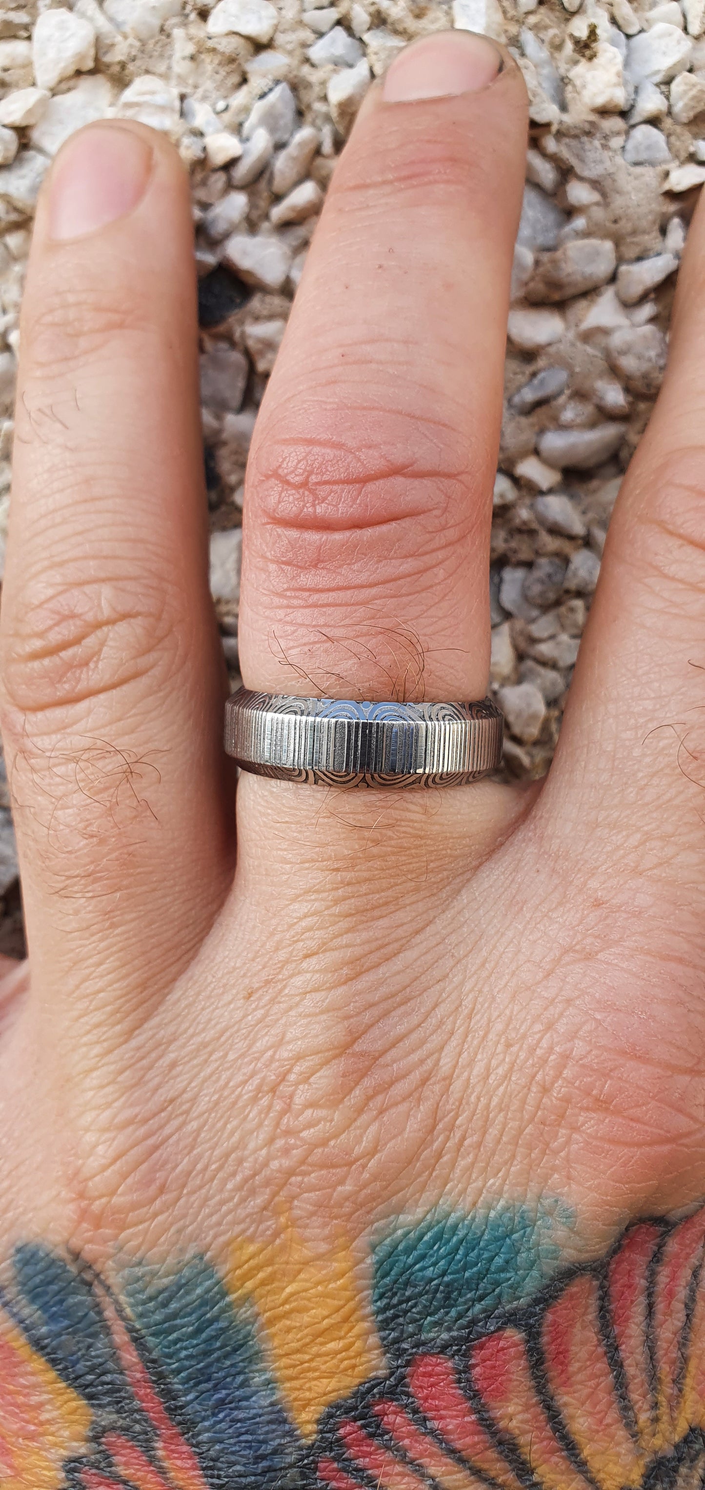 Unique handcrafted Damascus steel ring with bevelled edges