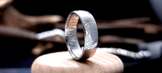Dee Damascus steel court shaped ring with layered forged pattern
