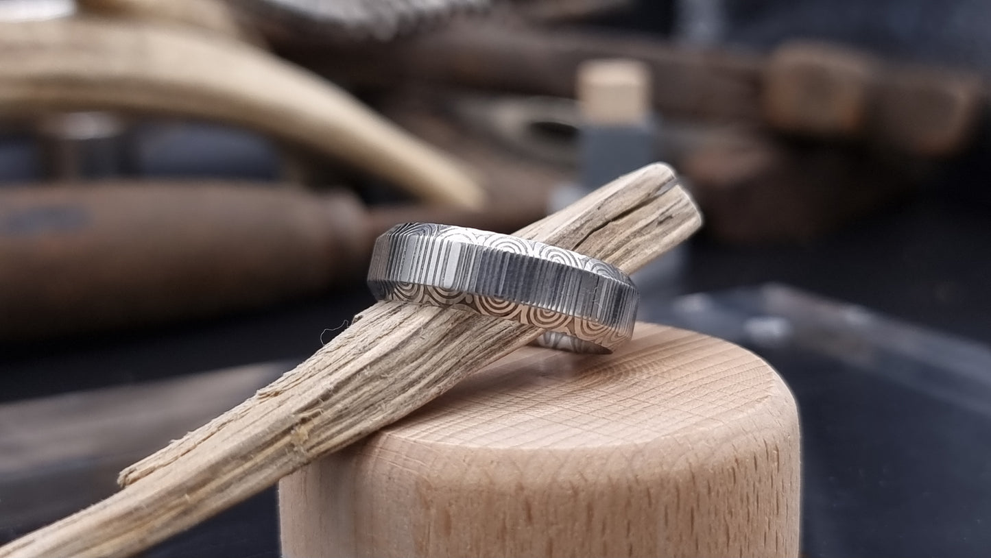 Unique handcrafted Damascus steel ring with bevelled edges