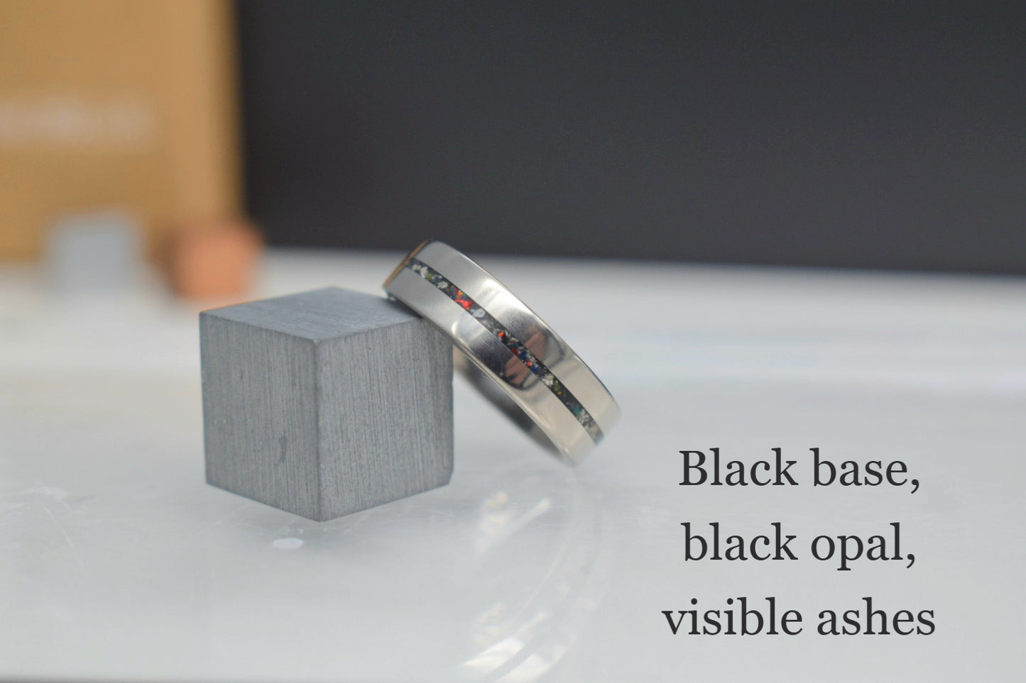Titanium memorial ring with single resin-filled channel for cremation ashes