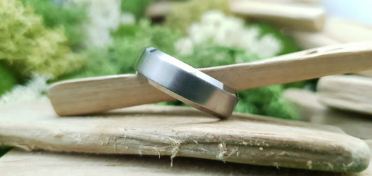 Handmade titanium ring with matte brushed texture and bevelled design