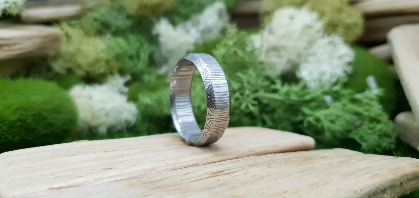 Unique handcrafted Damascus steel ring with bevelled edges