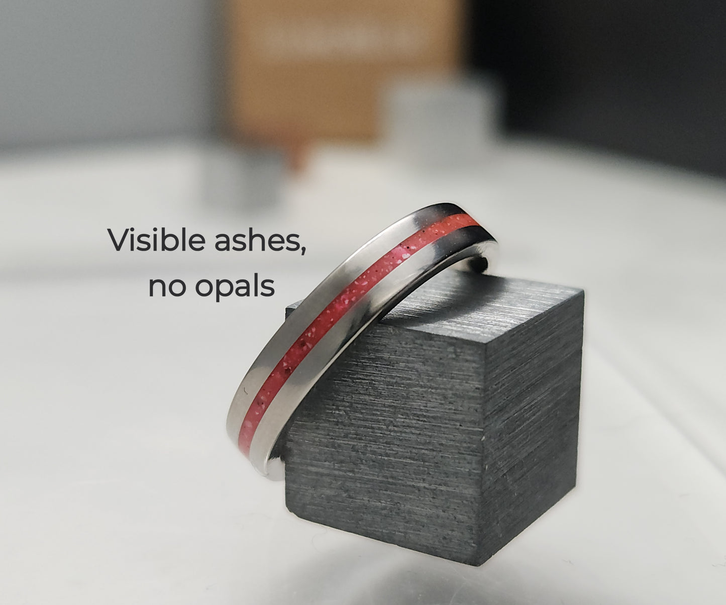 Titanium memorial ring with single resin-filled channel for cremation ashes
