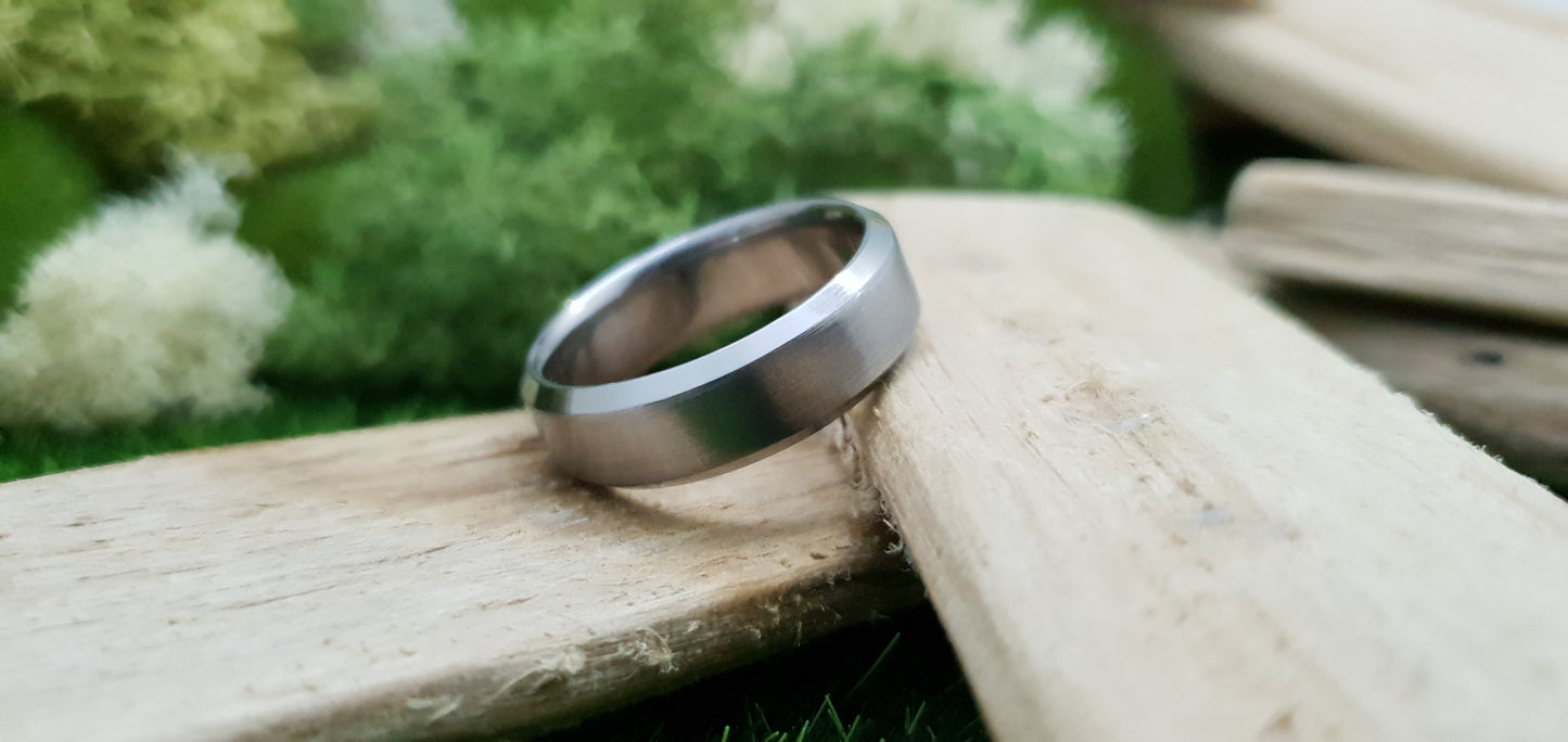 Handmade titanium ring with matte brushed texture and bevelled design