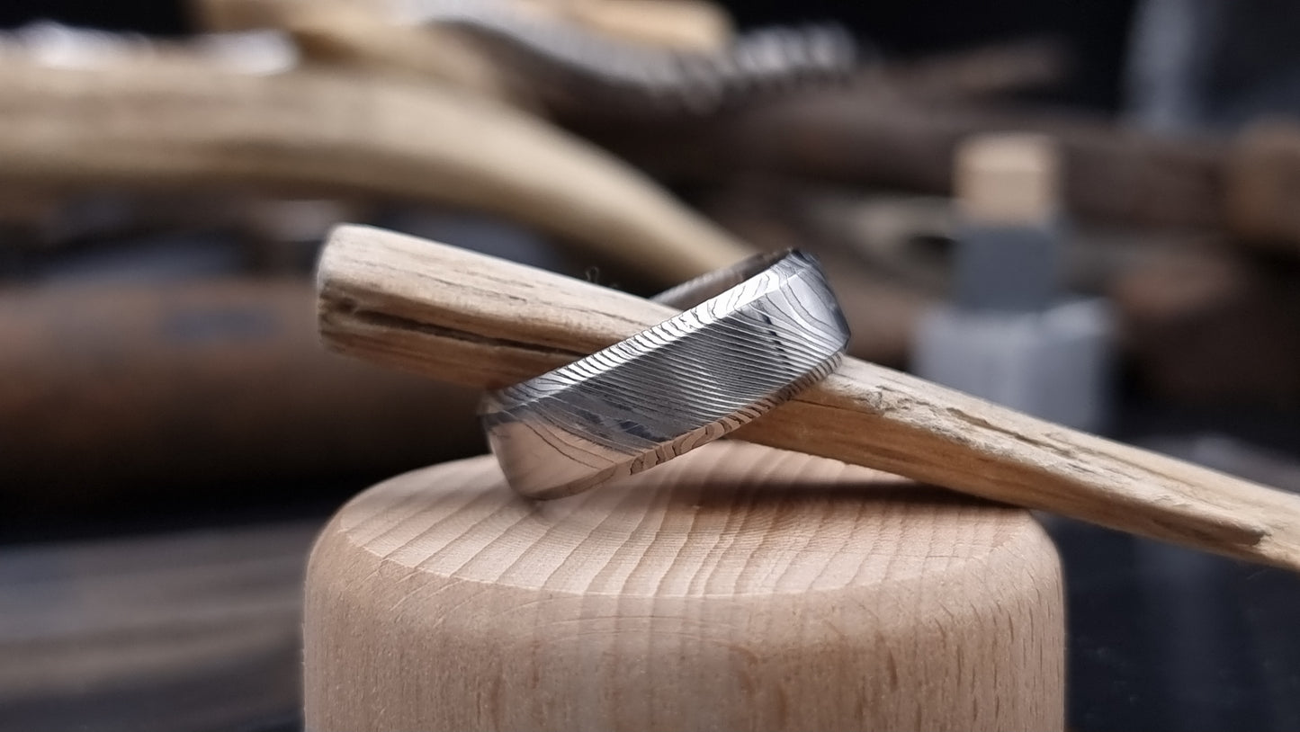 Handmade Damascus steel ring with bevel shape and distinctive finish