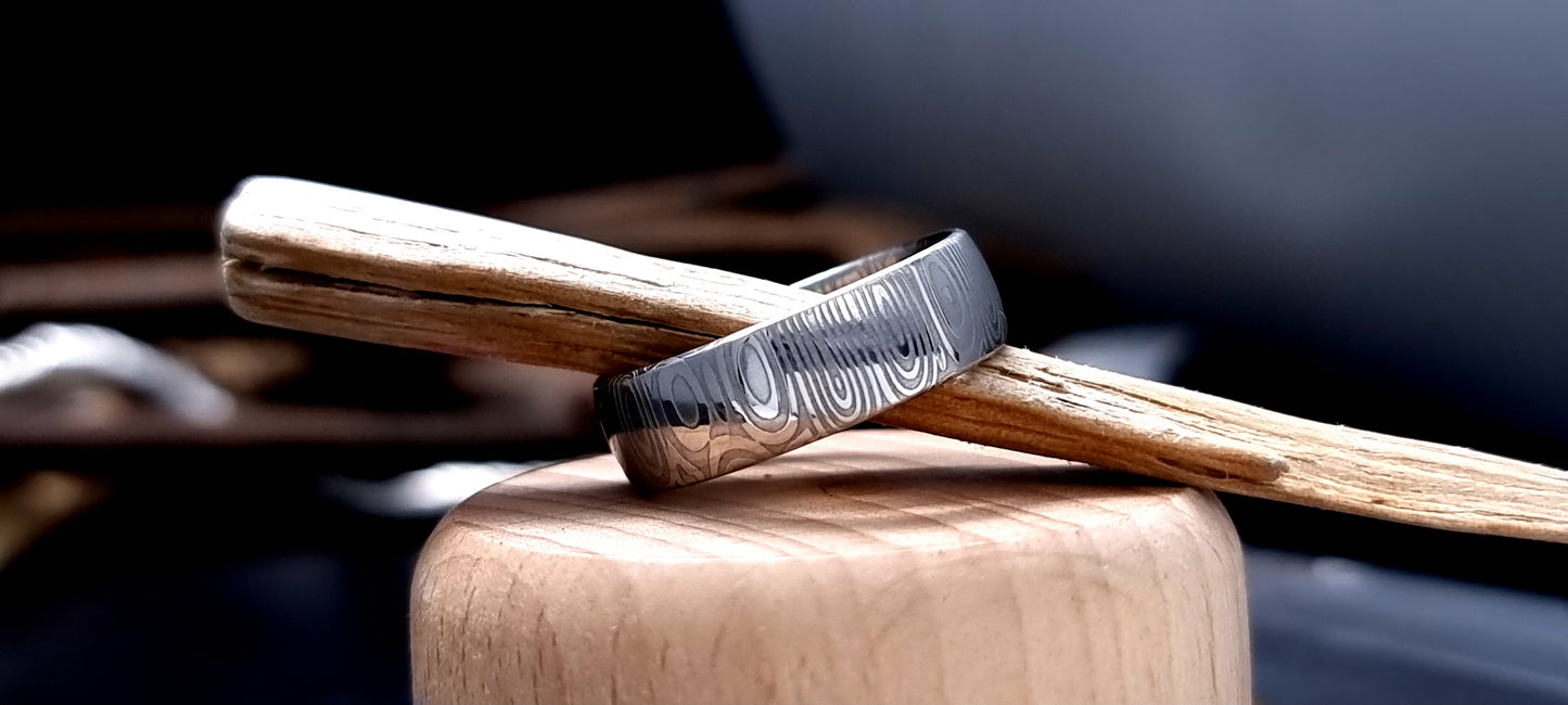 Dee Damascus steel court shaped ring with layered forged pattern