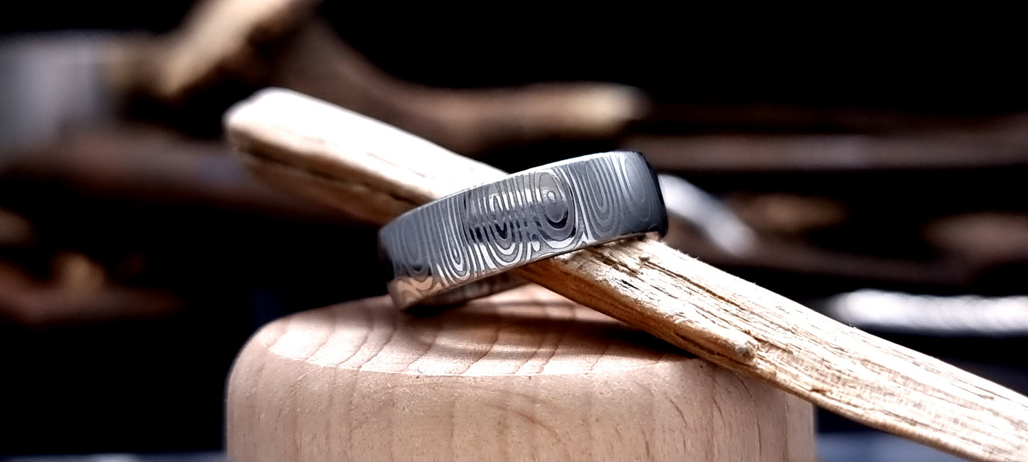 Dee Damascus steel court shaped ring with layered forged pattern