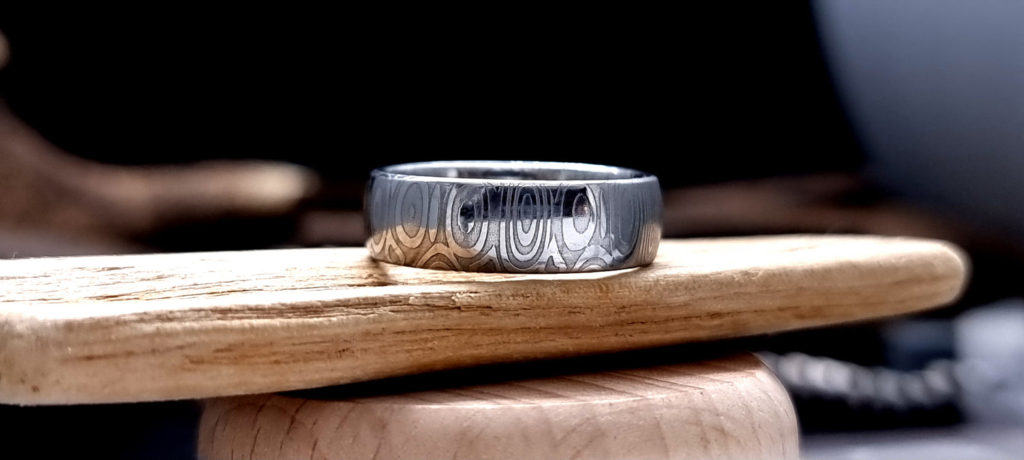 Dee Damascus steel court shaped ring with layered forged pattern