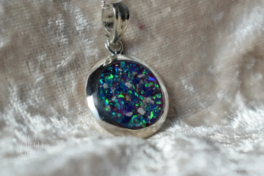 Large round silver cremation ashes necklace featuring a subtle and timeless design. Crafted from high-quality sterling silver, this handmade necklace preserves precious memories and offers a comforting keepsake. Designed in the UK, the necklace combines elegance and meaning, making it an ideal memorial jewellery piece.