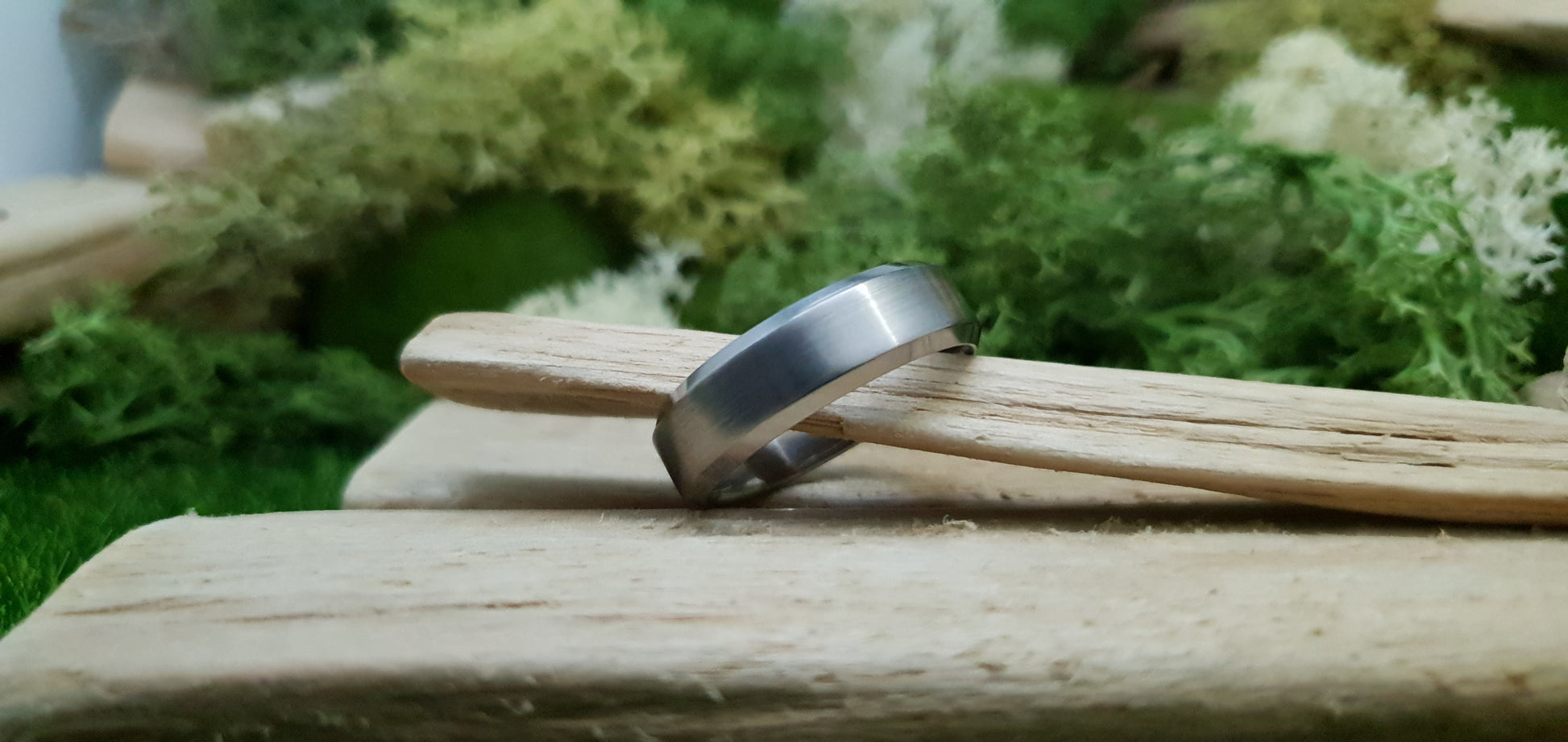 Handmade titanium ring with matte brushed texture and bevelled design
