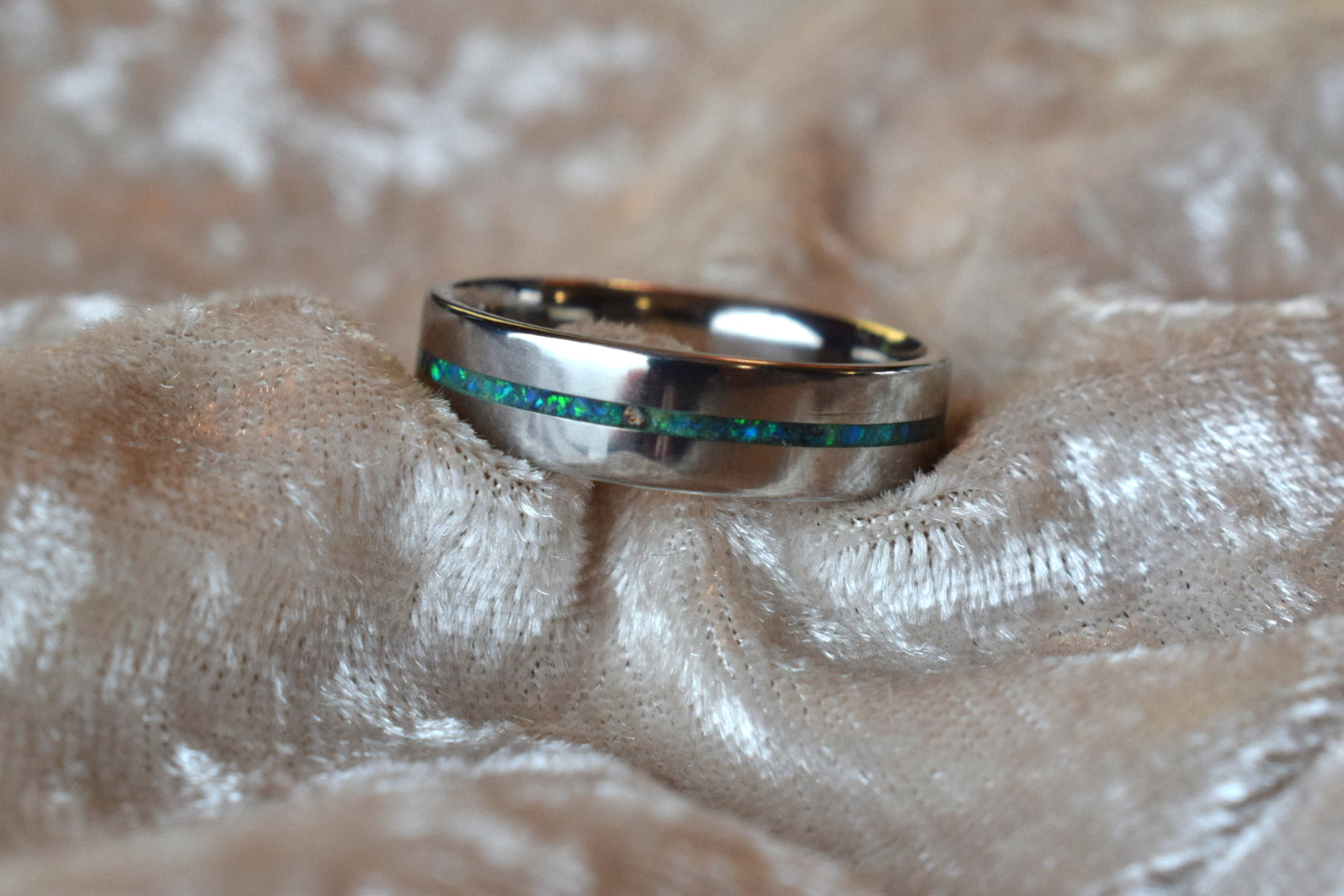 Titanium memorial ring with single resin-filled channel for cremation ashes