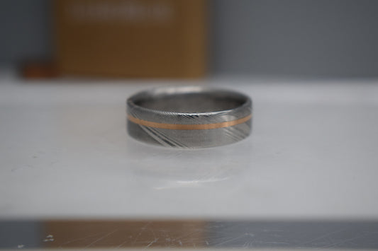 Unique men’s wedding ring combining Damascus steel and  gold inlay