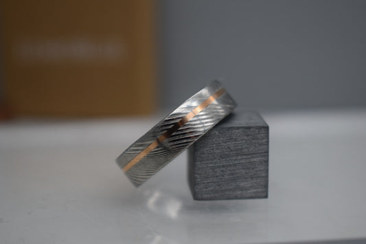 Unique men’s wedding ring combining Damascus steel and  gold inlay