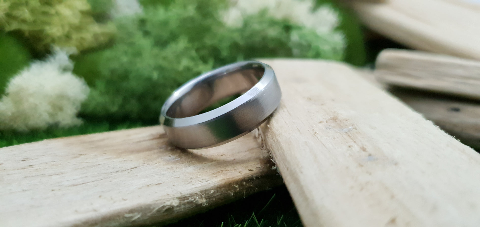Handmade titanium ring with matte brushed texture and bevelled design