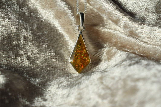 Kite-shaped silver memorial necklace with cremation ashes inside
