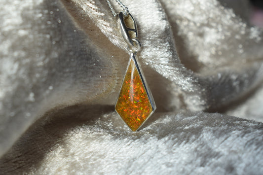 Kite-shaped silver memorial necklace with cremation ashes inside