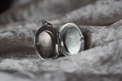 Sterling silver memorial locket necklace with classic oval design
