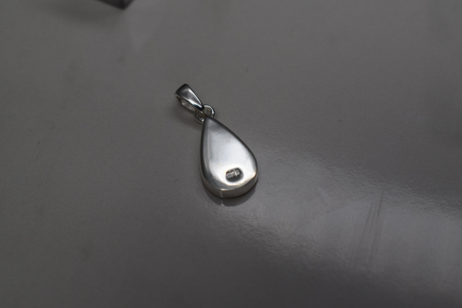 Handmade teardrop silver memorial ashes necklace with discreet ashes inlay, crafted in the UK