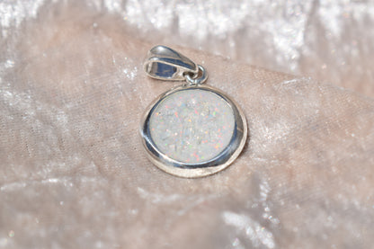 Large round silver cremation ashes necklace featuring a subtle and timeless design. Crafted from high-quality sterling silver, this handmade necklace preserves precious memories and offers a comforting keepsake. Designed in the UK, the necklace combines elegance and meaning, making it an ideal memorial jewellery piece.