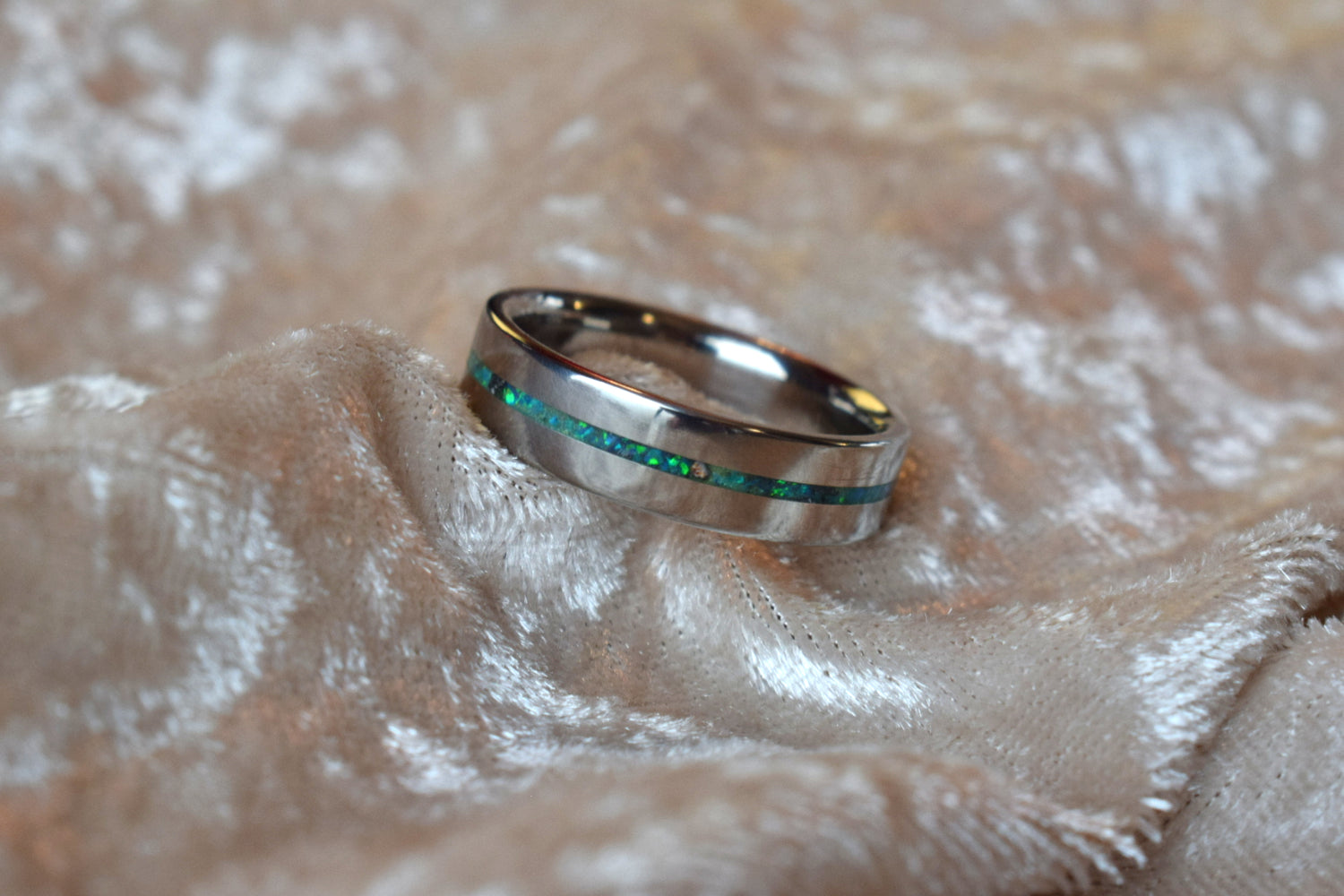 Titanium memorial ring with single resin-filled channel for cremation ashes