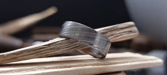 Men’s flat Damascus steel wedding band with bold natural etching