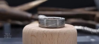 Men’s flat Damascus steel wedding band with bold natural etching