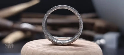 Men’s flat Damascus steel wedding band with bold natural etching