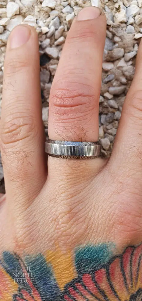 Unique handcrafted Damascus steel ring with bevelled edges