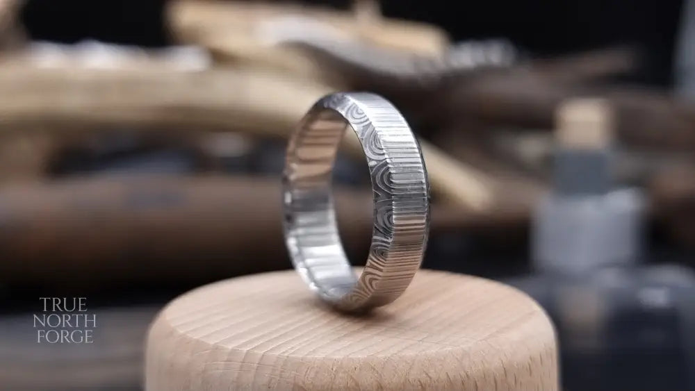 Unique handcrafted Damascus steel ring with bevelled edges