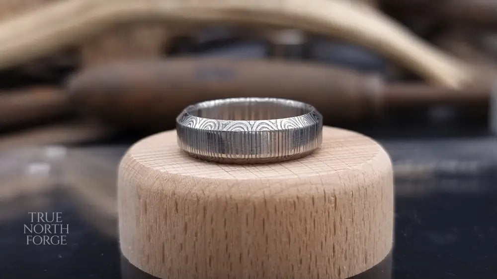 Unique handcrafted Damascus steel ring with bevelled edges