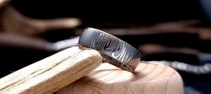 Unique men’s wedding ring in Cowie patterned Damascus steel