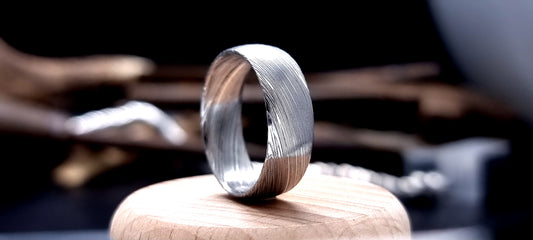 Court-shaped Damascus steel ring for men with rustic etched finish