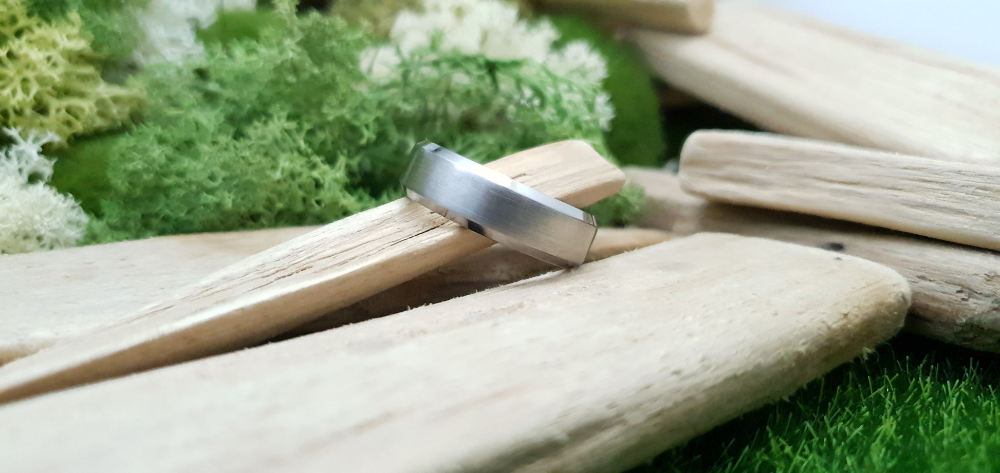 Handmade titanium ring with matte brushed texture and bevelled design