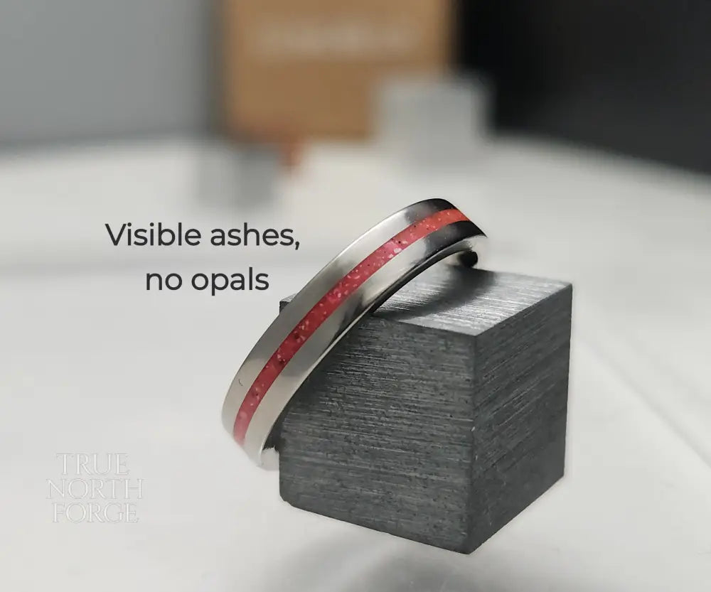 Titanium memorial ring with single resin-filled channel for cremation ashes