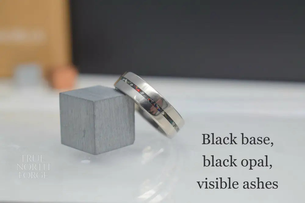Titanium memorial ring with single resin-filled channel for cremation ashes